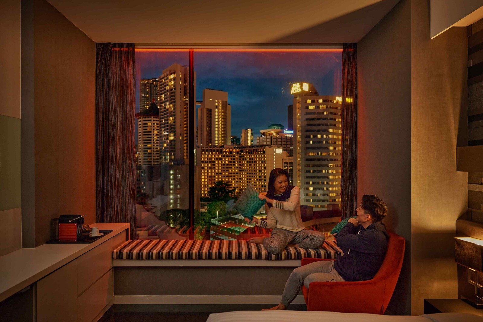 Room and seating area at Quincy Hotel Singapore
