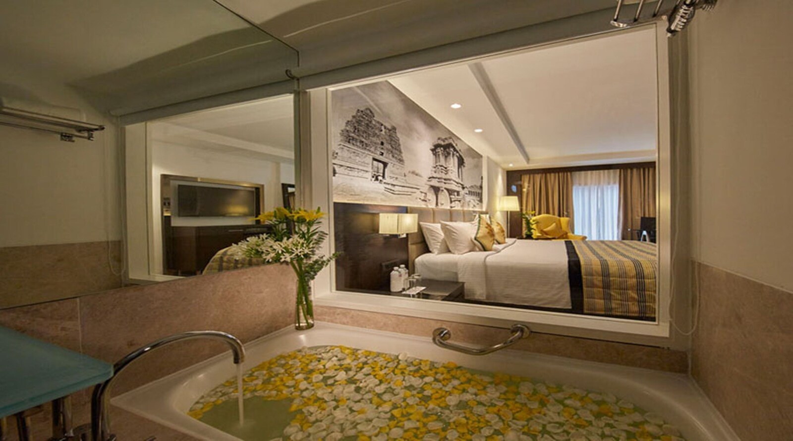 Bedroom and bathroom at Hotel Royal Orchid Bangalore